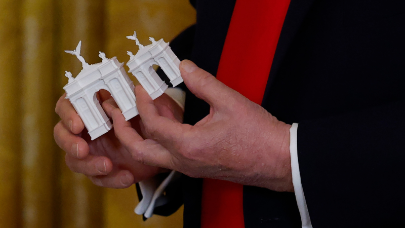 President Donald Trump‘s flair for personal imprints is expanding beyond the White House grounds. 
A reportedly privately funded monument, dubbed the ‘Arc de Trump,’ is planned to commemorate the nation’s 250th anniversary next year, the latest in a series of renovation and design projects the former real estate developer has pursued since returning to the White House. Trump offered a glimpse of the project last week in the Oval Office, showing a model positioned on a rendering of the National Mall.
At a White House ballroom fundraising dinner on Wednesday, Trump shared additional details about the newest monument planned for the nation’s capital. He said he was presented with three arch models in varying sizes — small, medium and large — and said his preference was for the largest one.
The monument, a near twin of Paris’s iconic Arc de Triomphe, is meant to welcome visitors crossing the Memorial Bridge from Arlington National Cemetery into the heart of the nation’s capital.
It’s unclear when construction on the arch will begin or how much it will cost. Trump said Wednesday evening that remaining funds from the new White House ballroom project will go toward financing the arch. 
The White House did not immediately respond to Fox News Digital’s request for further comment.
Meanwhile, the Trump administration has begun construction on a 90,000-square-foot White House ballroom. The sprawling addition, announced in July, will accommodate approximately 650 seated guests and will stay true to the classical design of the White House.
The White House currently lacks a formal ballroom, and the new structure is expected to replace the existing East Wing. White House press secretary Karoline Leavitt said the new ballroom is estimated to cost $200 million and will be financed by Trump as well as private donors.
The ballroom isn’t the only update. Trump has introduced gold accents in the Oval Office and Cabinet Room, lined the ‘walk of fame’ with portraits of former presidents, including a photo of the autopen representing former President Joe Biden’s time in office, added stone pavers to the Rose Garden lawn and installed two 88-foot flagpoles.
This post appeared first on FOX NEWS Trump reveals Arc de Triomphe-style monument for America’s 250th anniversary